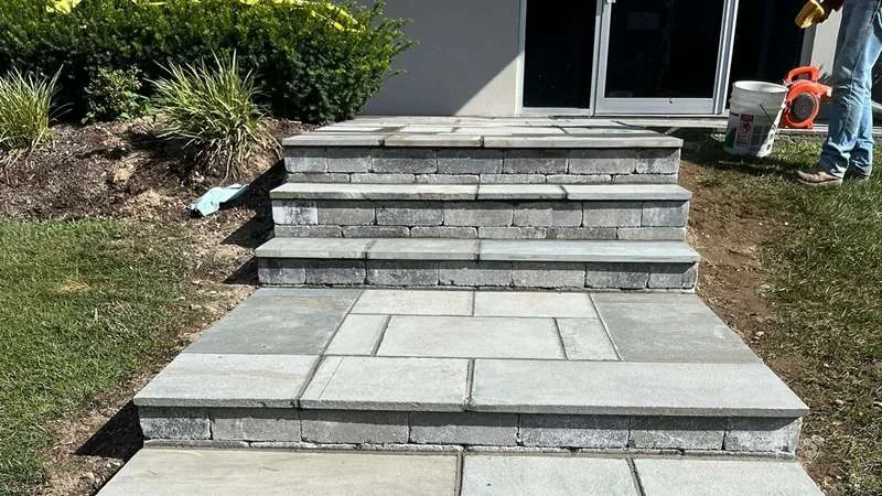 Wide stone treads and a landing at the front door.