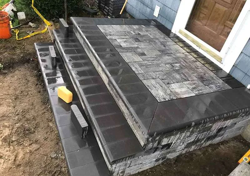 Paver and block platform built up to the door threshold.